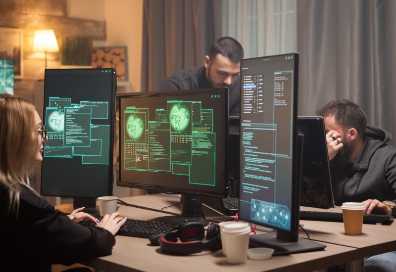 Female hacker with her team of cyber terrorists making a dangerous virus to attack the government.
